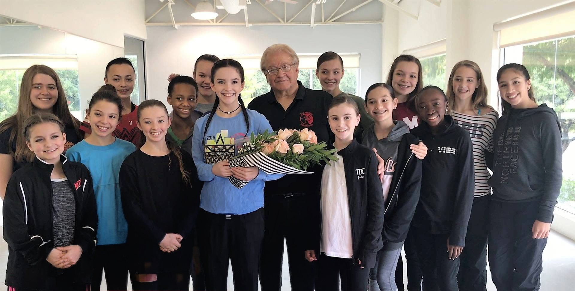 Founder E. John Busser with a group of young dancers in a studio