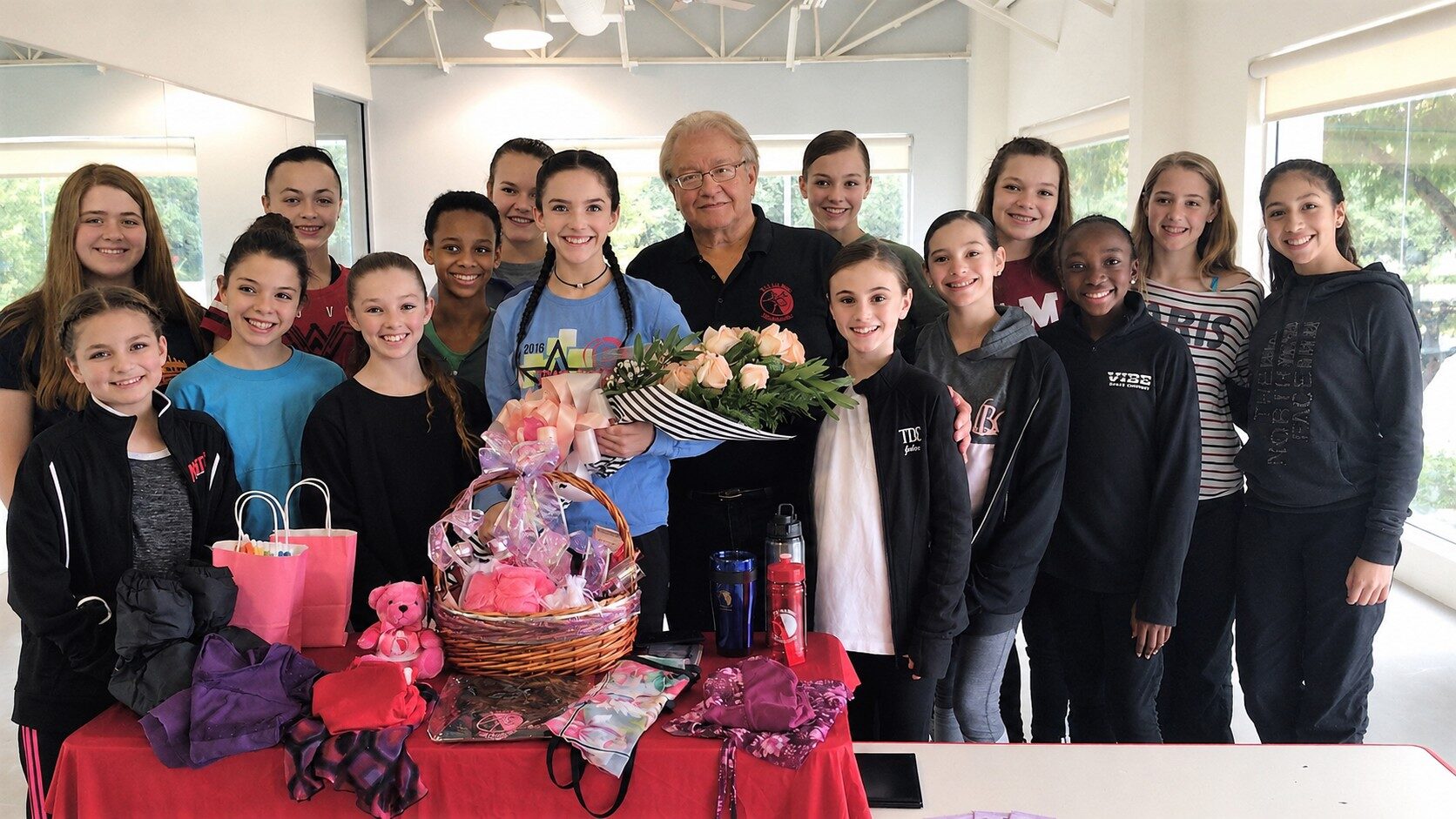 Founder E. John Busser with a group of young dancers in a studio
